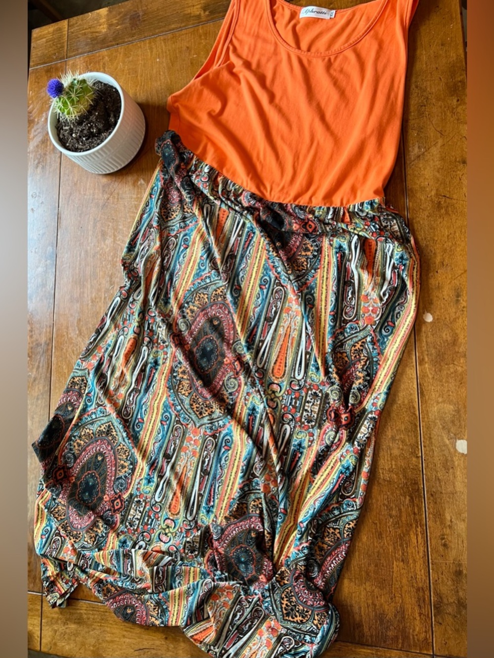 Maxi dress with orange sleeveless top and paisley pattered bottom